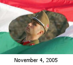 A soldier of the free Hungarian Republic peers through the revolutionary Hungarian flag