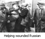 Hungarian helping a wounded Russian soldier. Many Russian troops defected to the Hungarian side. After the week of freedom, KGB head Yuri Andropov supplemented troops with Asian Soviet forces who were not sympathetic or aware of the rebellion.