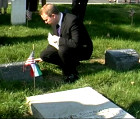 Bryan Dawson-Szilagyi placing the AHF commemorative ribbon on the Odon Gurovits Gravesite.