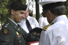 Lt. Col. Steve Vekony prepares the roll call list. Andy Evva signs.