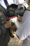 Lt. Col. Steve Vekony prepares the roll call list. Andy Evva signs.