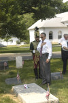 Akos Nagy lays the AHF ribbon on the Odon Gurovits family gravesite