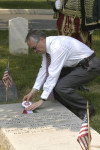 Akos Nagy lays the AHF ribbon on the Odon Gurovits family gravesite