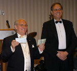 Frank Koszorus, Jr., President of the American Hungarian Federation, presents Dr. István Balogh, President of the Juvenile Cancer Foundation, with a check of the ball's contribution