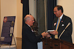 Frank Koszorus presenting the book "Daughter of the Revolution" to Dr. Lee Edwards