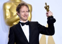 László Nemes holds up his Oscar for "Son of Saul"